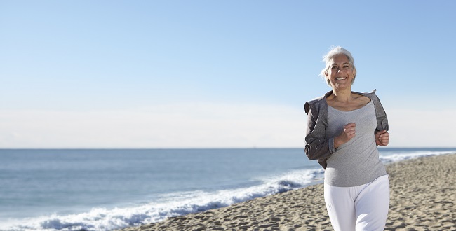 Mature woman jogging on beach